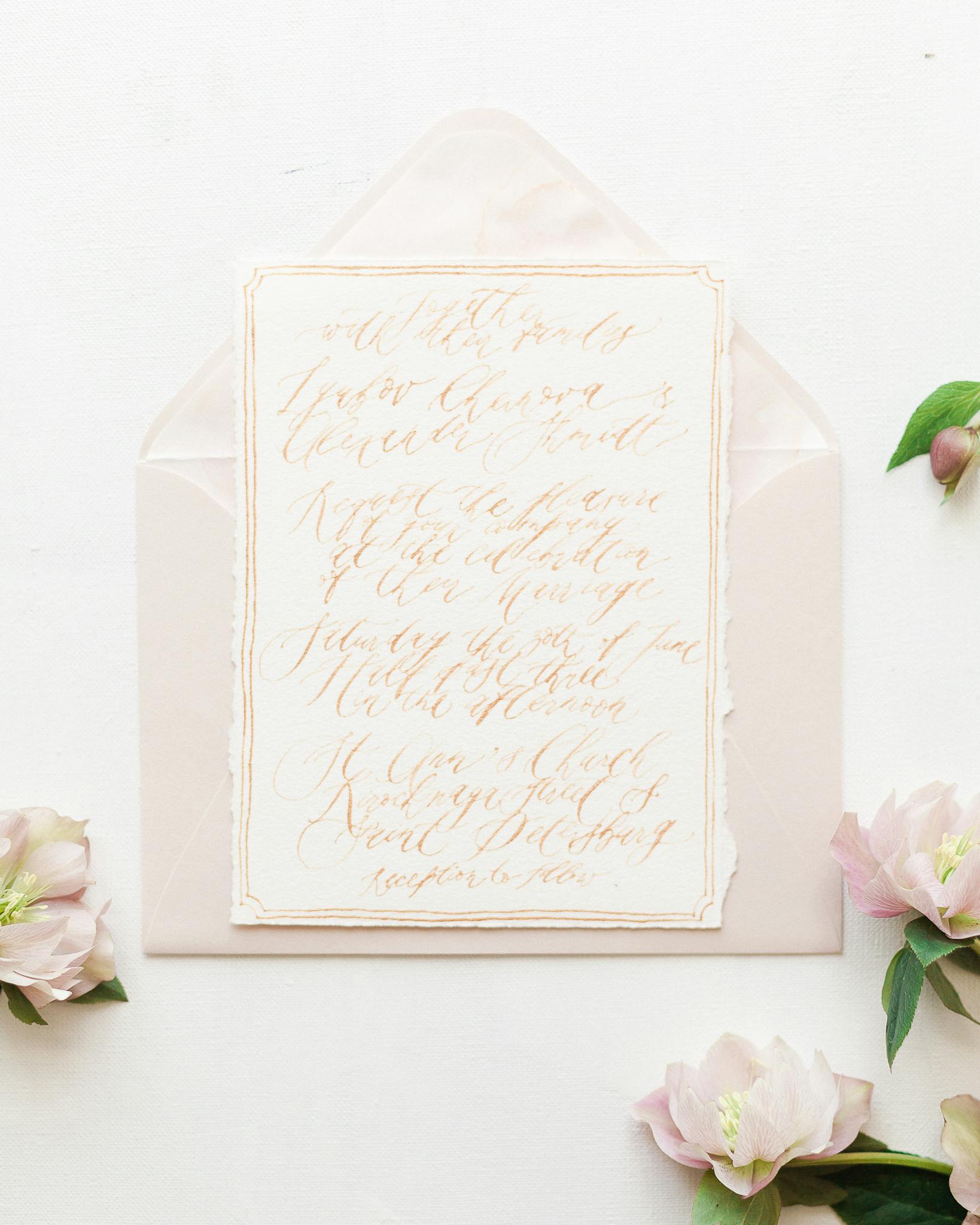A beautifully designed wedding invitation with soft pastel florals on a white background.